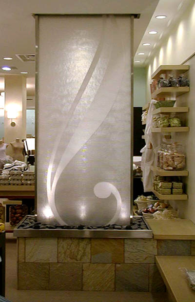 A white water wall with a design placed on the storefront